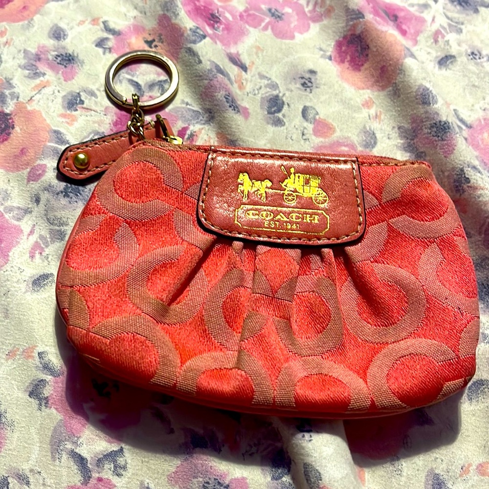 Coach monogrammed coral change purse used a few times but in good condition